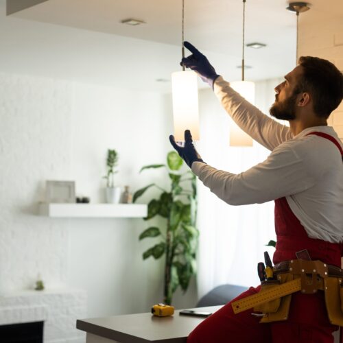 Electrician,Installing,Led,Light,Bulbs,In,Ceiling,Lamp